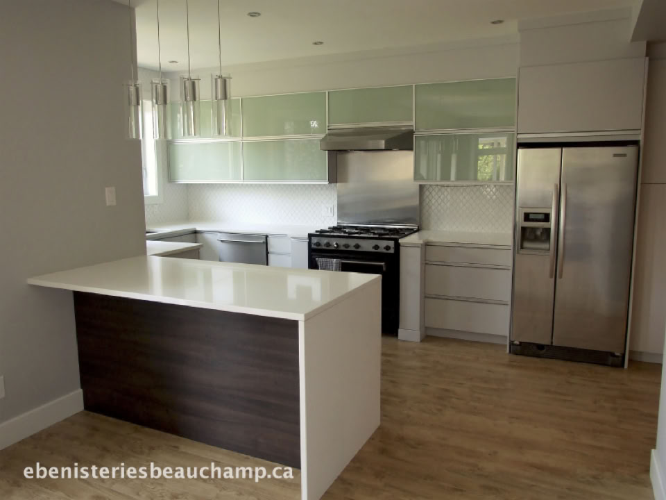 Modern kitchen with a central island, stainless steel appliances, white cabinets, and wooden flooring.
